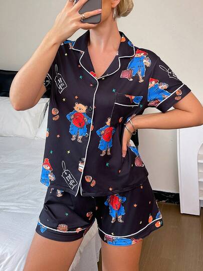 2pcs Black Paddington Bear Cartoon Print Short Sleeve Shorts Pajama Set, Comfortable Polo Collar Button Front Knit Top With Pockets & Elastic Waist Pants, Suitable For All Seasons Casual Loungewear