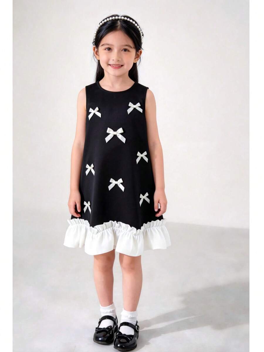 4-8岁女童优雅连衣裙 - 黑色无袖A字连衣裙，饰有白色蝴蝶结贴花和荷叶边下摆 | 适合派对、婚礼或特殊场合 - 黑色 - 查看 1