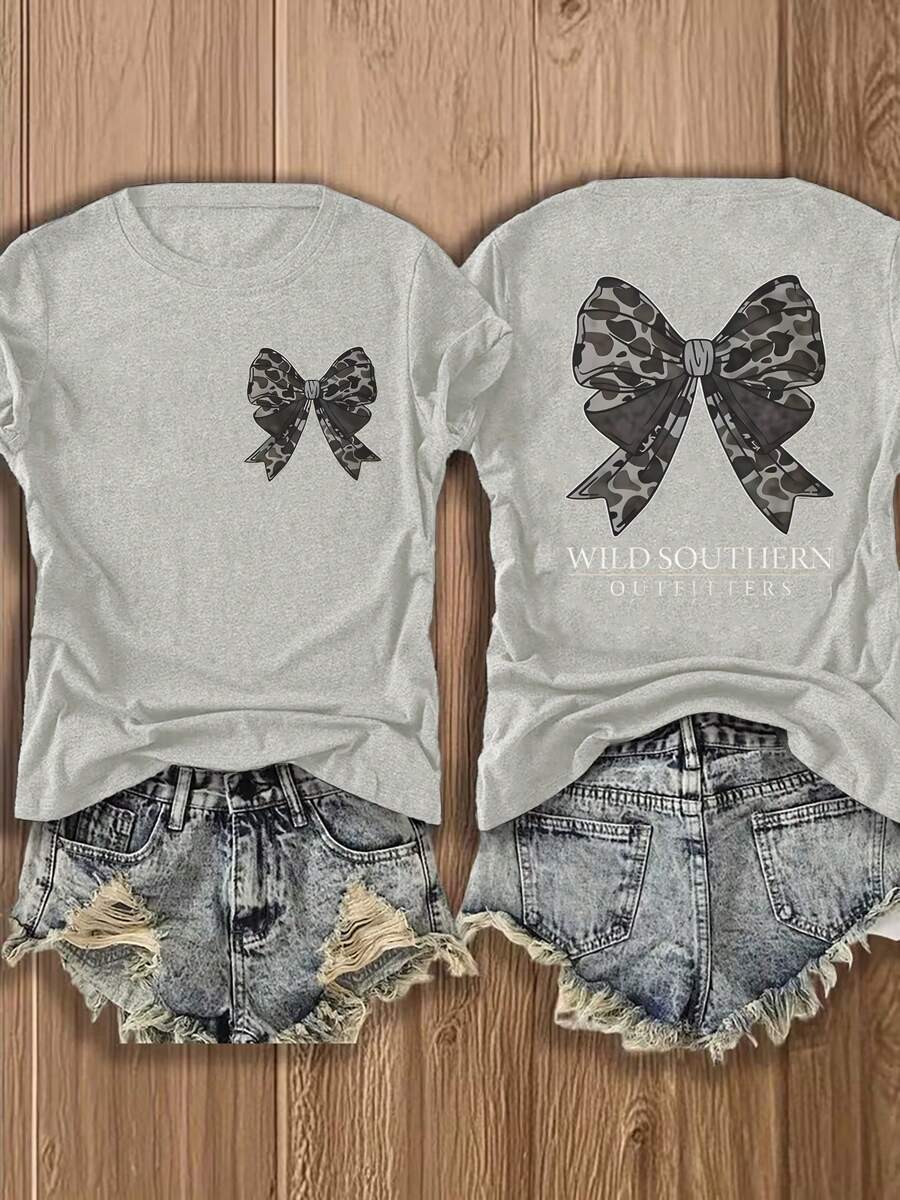 Nueva camiseta de moda para primavera y verano para niñas, estilo europeo y americano, cuello redondo, mangas cortas, ligera, transpirable, con estampado elegante, diseño cómodo, detalle de lazo, corte holgado, adecuada para uso diario y salidas, top deportivo casual versátil para uso urbano. - Negro - Ver 1