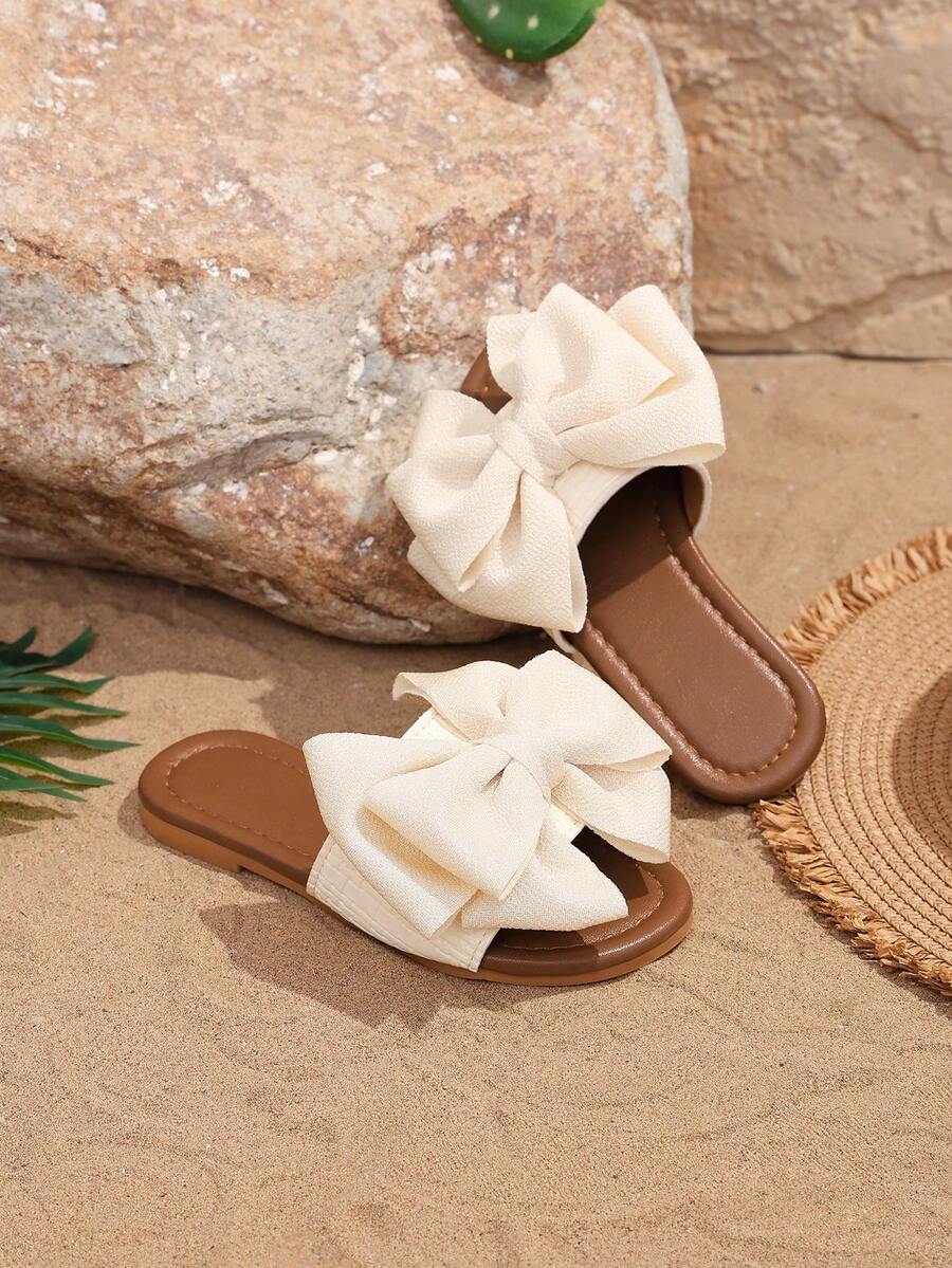 1 par de sandalias de playa para niñas de color beige, con un gran lazo y un diseño tejido, de material suave de PU con puntera redonda y suela plana, cómodas y tipo romano, adecuadas para niñas de 3 a 15 años para uso diario casual y vacaciones de verano, nuevo lanzamiento - Beis - Ver 1