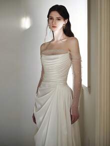 Elegant Off-Shoulder Satin Wedding Dress With Sheer Beaded Sleeves, Draped Bodice, And Sweep Train – Premium Heavyweight Satin Fabric, Fitted Mermaid Silhouette With Flared Hem, Off-Shoulder Neckline With Sheer Beaded Sleeves, Draped Bodice Detail, Sweep Train With Clean Hem, Available In Ivory – Perfect For Fall/Winter Indoor Church Weddings, Elegant Ballroom Ceremonies, And Modern Receptions, Luxurious And Structured Design, Ideal For Cooler Weather, International Export Quality, Suitable For Global Bridal Market - trắng - Xem 4