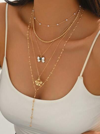 Bộ 5 chiếc dây chuyền ngọc trai giả thủ công cổ điển thanh lịch với mặt dây chuyền hình bướm và hoa duyên dáng, thích hợp để đeo hàng ngày, đi chơi, dự tiệc, du lịch. Có thể đeo nhiều lớp hoặc riêng lẻ. Độ dài dây có thể điều chỉnh.