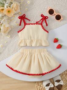 Bộ 2 món mùa hè ngọt ngào, kiểu retro gồm áo hai dây viền bèo nhún và chân váy ngắn thêu hình dâu tây, trang phục thường ngày. - Nhiều màu - Xem 3