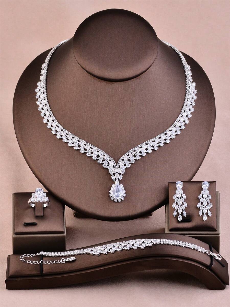 CORUIXI Juego de joyería de 4 piezas de lujo y elegante con zirconia cúbica en forma de lágrima para mujer, que incluye collar, aretes, pulsera y anillo. Collar de gargantilla de cristal y diamante brillante de plata adecuado para novia, dama de honor o regalo de cumpleaños. - Plateado - Ver 1
