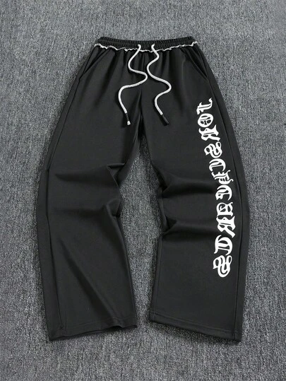 1件男士宽松休闲运动裤，采用简约纯色阔腿设计，配有抽绳腰带和大口袋，适合日常行走、工作、旅行和其他场合。