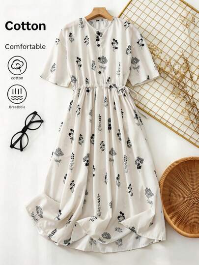 春夏新款女士休闲白色植物印花圆领系腰短袖纽扣中长连衣裙，适合夏季日常穿着