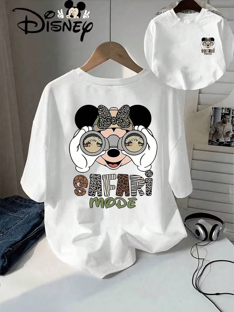 Authentic Disney Design Includes Minnie Mouse Wearing Leopard Print Bow And Handheld Binoculars With Zebra And Giraffe Silhouettes. The SAFARI MODE Lettering With Animal Textures Below Features The Disney Logo And A Small Mickey Minnie Avatar In The Upper Left Corner. Disney's New Summer Short Sleeved T-Shirt Top For Women Is A Casual And Fashionable Printed T-Shirt For Women, Disney Shirt, Disney Shirts, Summer Outfits For Women, Spring Outfits For Women, Officially Licensed Disney T-Shirts, Disney Men's And Women's Spring/Summer Fashion Casual Short-Sleeve T-Shirts - trắng - Xem 1