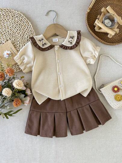 女童学院风罗纹套装，娃娃领短袖衬衫+防闪褶皱短裙，韩版甜美风，透气舒适，适合春夏穿着，上学和外出皆宜。