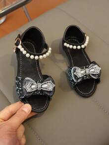 2026 Nuevas sandalias de malla con rhinestones para niñas, decoradas con lazo de perlas, suela gruesa y suave, punta abierta, estilo princesa, adecuadas para uso diario y disfraces de actuación - Negro - Ver 1