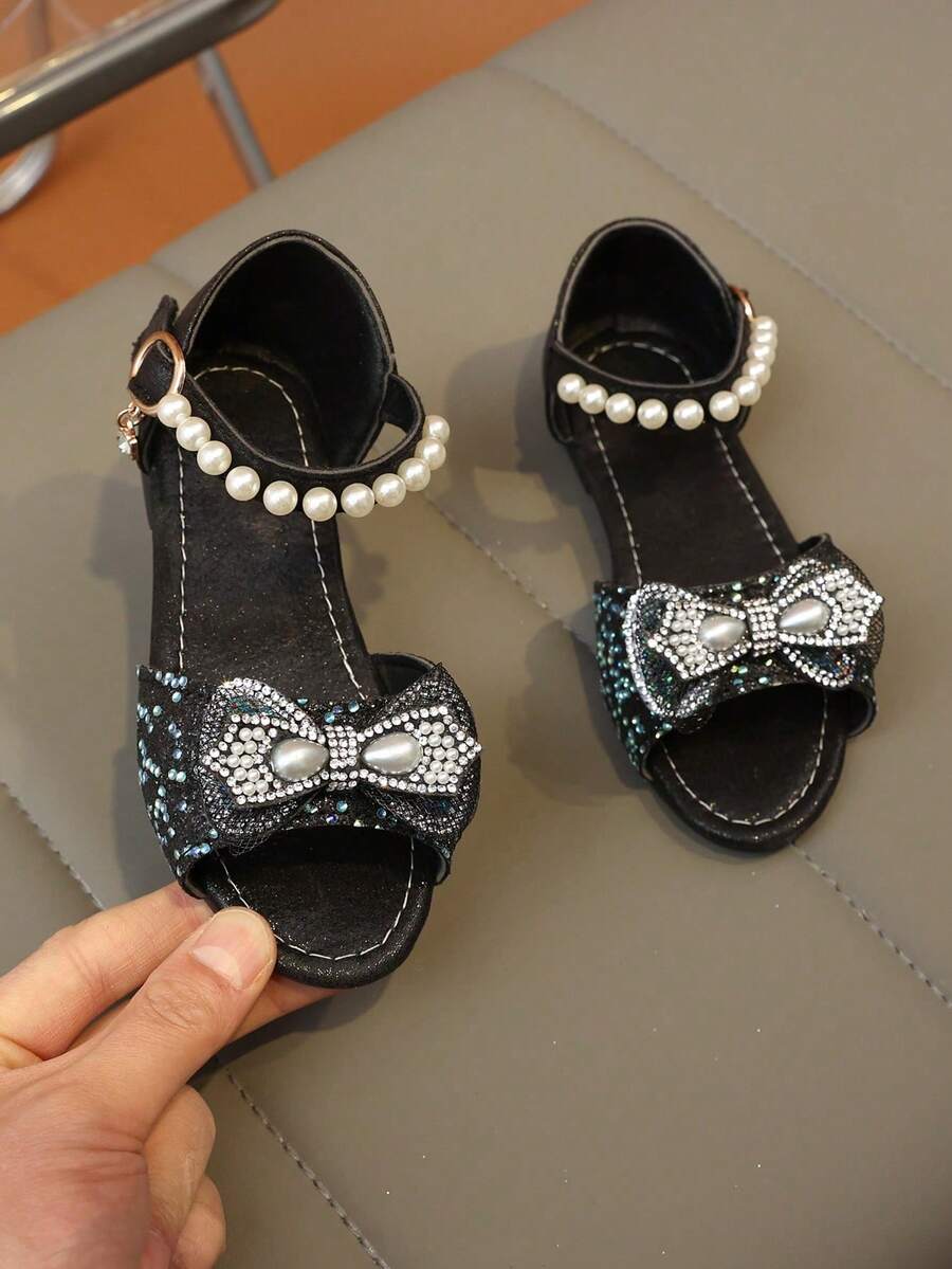 2026 Nuevas sandalias de malla con rhinestones para niñas, decoradas con lazo de perlas, suela gruesa y suave, punta abierta, estilo princesa, adecuadas para uso diario y disfraces de actuación - Negro - Ver 1