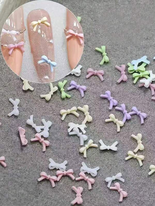 100Pcs Nail Art Accessories, MacaronColor 3D Bows, Size M (Medium), In White,Green, Pink, Purple, Blue, Yellow, Beige -Assorted Colors Randomly Mixed. Perfectfor Creating Various Nail Art Styles, CuteStyle, Spring/Summer DIY Decoration Accessories. Suitable For Matte And GlossyNails, Long Nails, Short Nails, Almond-Shaped Nails, Ballet Nails, French TipNails, And More.