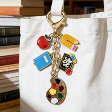 1 bộ dụng cụ vẽ tranh sơn dầu bằng hợp kim cổ điển, gồm bảng vẽ, bút chì, quả táo, thước kẻ, bút màu, văn phòng phẩm, móc khóa, quà tặng cho giáo viên nhân Ngày Nhà giáo hoặc lễ tốt nghiệp, móc treo túi xách và chìa khóa. - Nhiều màu - Xem 5