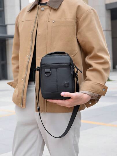 男士商务斜挎包，黑色纯色尼龙材质，防水，多口袋设计，拉链封口，适合日常通勤。