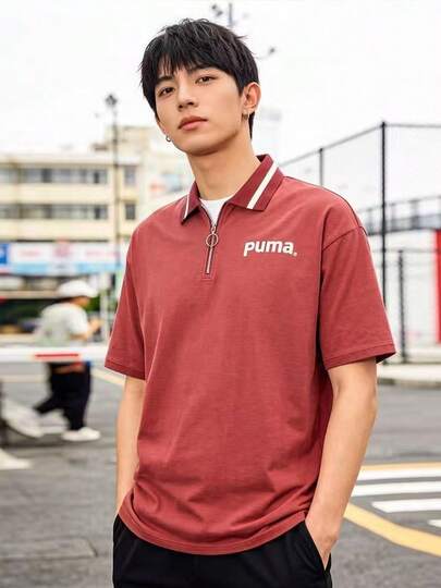  Áo polo nam tay ngắn, in logo PUMA, màu tím, có khóa kéo.