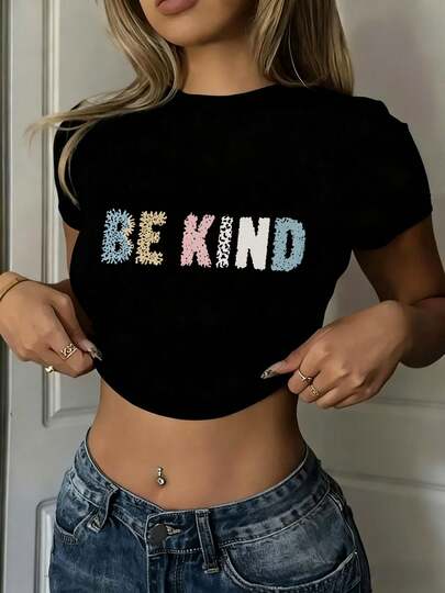 Black Crop Top Wowomen Brand "BE KIND" Printed Cropped T-Shirt, Featuring Colorful Plush Lettering Design, Paired With Blue Denim Pants, Accented With A Silver Belly Button Ring And Multiple Rings, A Casual Cropped Top That Perfectly Suits  Summer Everyday Wear.2026-Petite Women Clothing, Pink, Going Out Top, Y2k