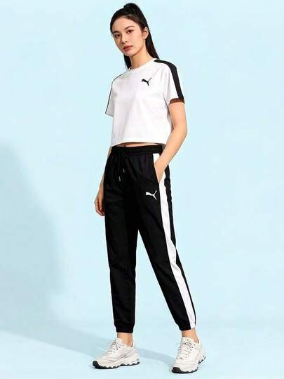  Quần thể thao nữ PUMA Iconic T7 dệt kim với logo thêu, phối màu và kiểu dáng jogger cổ điển.