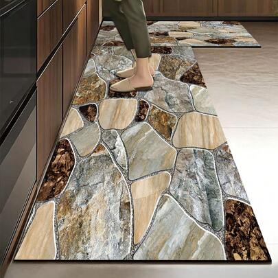 Thảm bếp bằng gel silica 1 chiếc với thiết kế khảm đá tự nhiên bất đối xứng chân thực, có kết cấu giống đá nhiều màu sắc với các tông màu xám, nâu và be, được viền bởi các đường kẻ trắng mảnh để tái tạo vẻ ngoài của đá lát đường cổ điển, mang lại hiệu ứng 3D và tự nhiên ấn tượng. Thảm bếp cao cấp thời trang này có đặc tính giảm chấn và chống mỏi, với bề mặt vải, lớp giữa là chất liệu xốp thấm hút và đáy cao su chống trượt giúp dễ dàng vệ sinh.