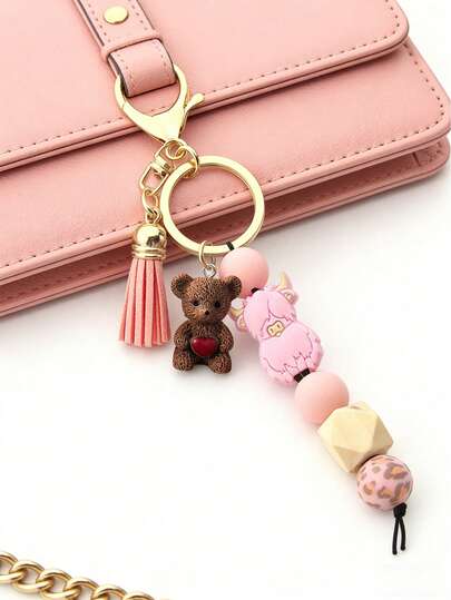 1 pieza Lindo llavero con cuentas de silicona en forma de oso pequeño con borla, llavero corto y lindo, estilo punk de dibujos animados, tema animal, llavero de oso de resina con corazón, accesorio para mochila, colgante de acrílico, cadena anti-pérdida para llaves de coche, para coche, teléfono, mochila, billetera, auriculares, regalos para amantes de las mascotas, regalos para familiares, amigos, seres queridos, regalos de cumpleaños únicos, regalos navideños, regalos para fiestas, regalos del Día de la Madre, regalos de vuelta a la escuela