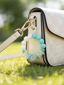 1 pieza Llavero con cuentas para el Día de la Madre, Dije con letras "MOM" iridiscente tipo macaron, diseño versátil de muñequera que libera las manos, conveniente para uso diario - multicolor - Ver 12