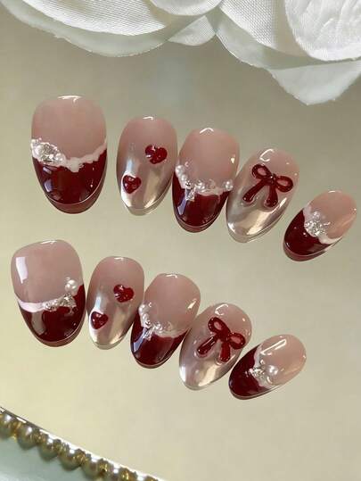 10 miếng dán móng tay hình bầu dục ngắn, kiểu dáng cổ điển ngọt ngào, thủ công tinh tế, nền hồng nude trong suốt vẽ tay theo phong cách Y2K với viền trắng kiểu Pháp màu đỏ tía, hình trái tim và nơ ngọc trai 3D có thể tháo rời, phụ kiện móng tay thời trang giúp kéo dài ngón tay.