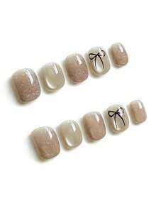 10pcs It Features An Elegant Palette Of Shimmering Nude Beige And Creamy Ivory, Adorned With Delicate Hand-Drawn Black Bow Motifs And Subtle Silver Glitter Accents, Exuding A Gentle And Sophisticated Vibe. The High-Shine Glossy Finish And Short Square Shape Create A Sleek, Versatile Daily Texture That Complements Any Outfit. Press On Nails - Apricot - View 2