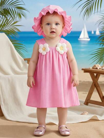Đầm không tay cho bé gái kèm mũ, trang trí 2 họa tiết hoa trắng trên vai, dáng chữ A rộng rãi, ngọt ngào, dễ thương, năng động và tinh nghịch, trang phục mùa hè không thể thiếu.