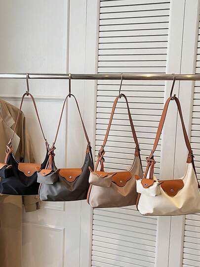 Túi đeo chéo ngắn tay phối da và nylon, màu tương phản, khóa kéo và nút bấm kép, kèm phụ kiện trang trí và ví đựng tiền xu, kiểu dáng sang trọng, nhẹ nhàng, phù hợp cho văn phòng, học sinh, đi làm hàng ngày.