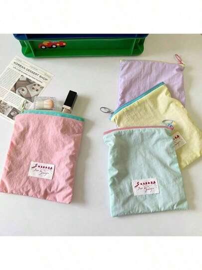 女士便携式化妆包（1个），兼具卫生巾收纳袋、小型个人包的功能，可存放卫生巾、口罩等；新款马卡龙色化妆包，便携可爱小包，可存放零钱、首饰和小饰品