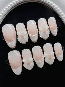 Bộ 10 miếng dán móng tay thủ công, màu nude, đầu móng kiểu Pháp màu trắng, trang trí nơ 3D và ngọc trai, kết hợp giữa vẻ thanh lịch kiểu Pháp và nét ngọt ngào nữ tính, phù hợp cho các quý cô và bé gái sử dụng trong các bữa tiệc, ngày lễ và các dịp hàng ngày suốt mùa xuân, hè, thu và đông. - trắng - Xem 2