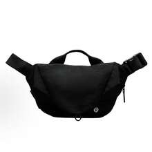 Lululemon Curved Crossbody Bag 3L | Ergonomic Half-Moon Silhouette | Water-Repellent High-Density Nylon | Interior Organization Pockets | Adjustable Strap For Custom Fit | The Ultimate Minimalist Essential - Black - View 1