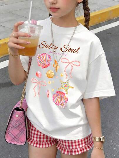 Designed Specifically For Tween Girl, This Casual Features A White Crew-Neck T-Shirt Paired With Red Plaid Shorts, Adorned With A "Shell Bow" Graphic Print-Making It The Perfect Choice. It Is Suitable For A Wide Variety Of Occasions, Looking Perfectly Appropriate Whether For School, Shopping, Everyday Wear