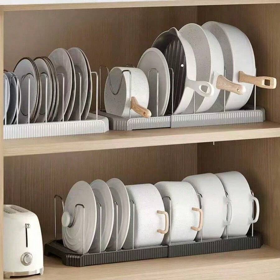 1 chiếc kệ đựng đồ nhà bếp có thể mở rộng, dùng để đựng nắp nồi, dụng cụ nhà bếp, nồi chảo, có thể đặt trên mặt bàn hoặc trong ngăn kéo, tiết kiệm không gian và đa chức năng.