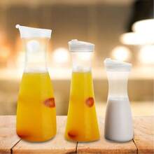 Este jarra de agua de acrílico de alta calidad cuenta con un diseño de tapa abatible y está hecha de material transparente resistente a los golpes. Es resistente al calor y a prueba de fugas, lo que la convierte en ideal para almacenar té helado, limonada, jugos de frutas, café, leche y otras bebidas frías. Es adecuada para su uso en cocinas domésticas, restaurantes, bares y cafeterías. - Multicolor - Ver 5