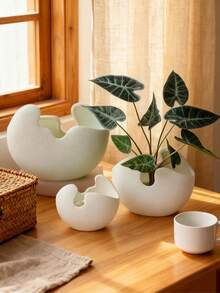 这款不对称造型的艺术树脂花瓶兼花盆非常适合在咖啡桌、书桌或窗台上摆放小型植物或枝条。它能为现代生活空间和办公室增添简约自然的氛围。 - A - 查看 5