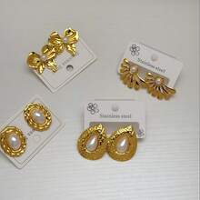 24件套金银厚款耳环，精致优雅的女士珠宝套装，包括银色心形耳环、银色蝴蝶结耳环、不规则螺旋耳环、珍珠蝴蝶结耳环、珍珠水滴耳环、珍珠翅膀耳环、海星耳环和耀眼太阳耳环。 - 彩色 - 查看 7