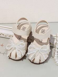 1 đôi dép xăng đan cho bé gái, giày công chúa đính nơ ngọc trai mùa hè mới cho trẻ em, giày tập đi đế mềm chống trơn trượt cho trẻ nhỏ. - Màu be - Xem 6