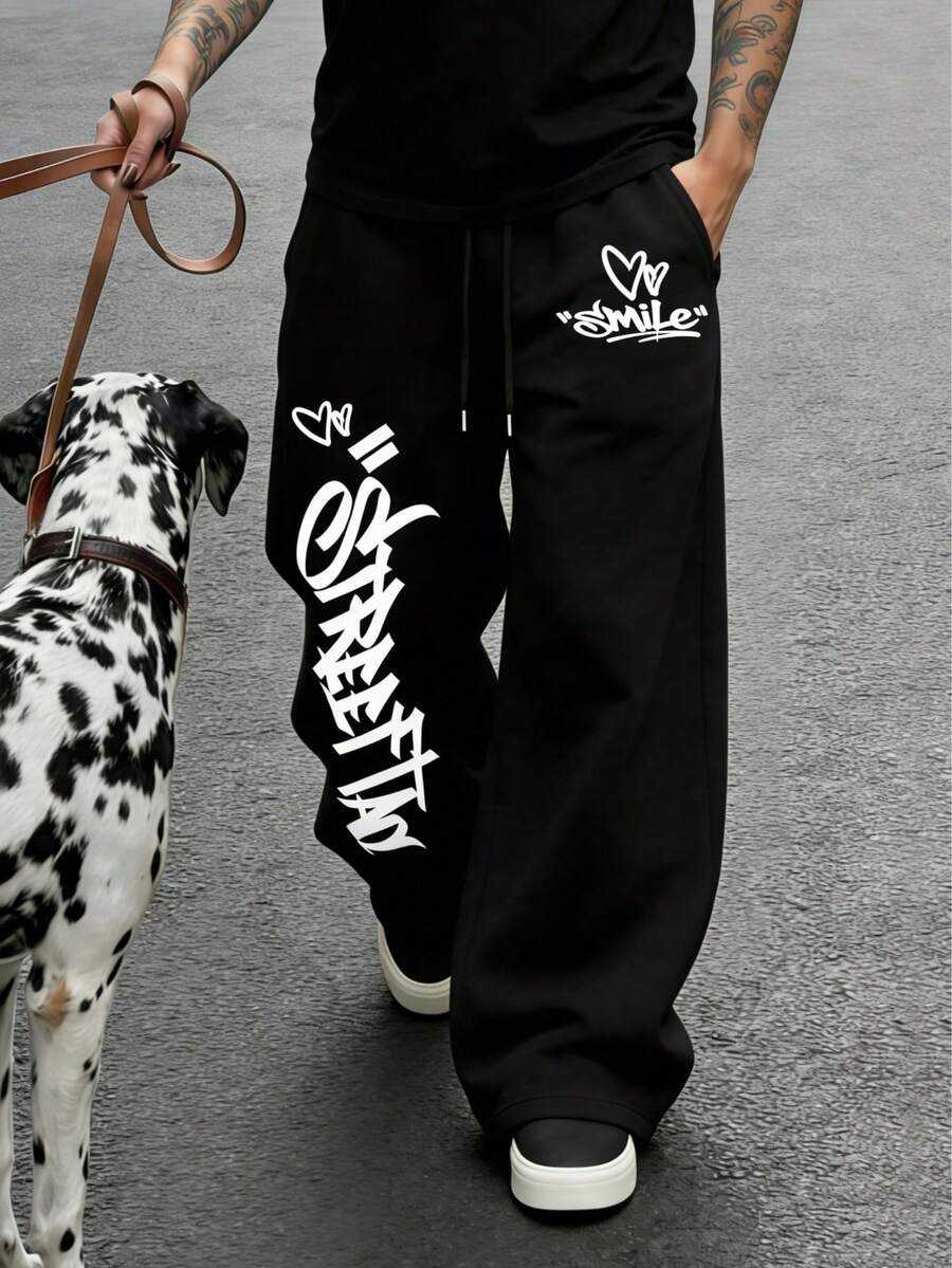 Pantalones de chándal negros de moda urbana para hombres, diseño creativo con estampado de corazón y letras en estilo graffiti, versátiles y cómodos de tela suave - Negro - Ver 1