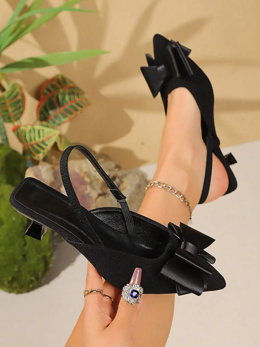 Sepatu hak tinggi wanita yang elegan dan seksi dengan hiasan pita, desain ujung runcing, nyaman dipakai, cocok untuk acara pesta.