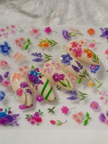 精致花卉美甲贴纸，包含色彩缤纷的雏菊、薰衣草、铃兰、郁金香、叶子和对比鲜明的线条元素。适合春日郊游、下午茶、度假拍照和日常通勤等场合。是美甲新手、花卉爱好者、时尚女性和学生DIY美甲的理想之选。 - 彩色 - 查看 4
