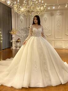 Luxury Long Sleeve V-Neck Ball Gown Wedding Dress With Crystal Beading, Tulle Skirt, And Cathedral Train – Premium Lace And Tulle With Hand-Applied Crystal Embellishments, Fitted Bodice With Boning, V-Neckline With Illusion Lace, Cathedral Train With Lace Edging, Available In Ivory – Perfect For Fall/Winter Indoor Weddings, Palace Ceremonies, And Destination Weddings, Warm And Elegant Design, Ideal For Cooler Weather, International Export Quality, Suitable For Global Bridal Market - trắng - Xem 2
