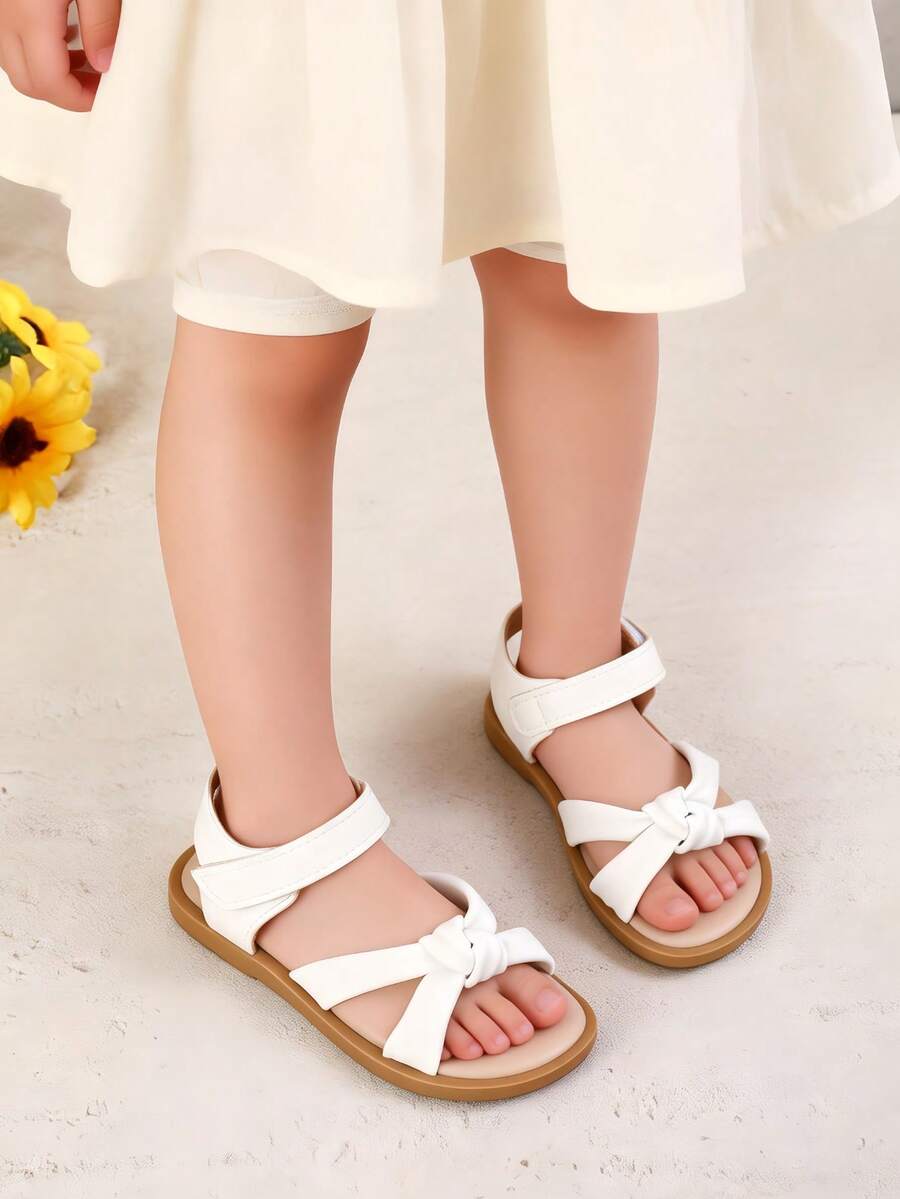 1 đôi dép xăng đan mùa hè kiểu Âu và Mỹ mới cho bé gái, giày bé gái, giày trẻ em, dép xăng đan trẻ em, dép xăng đan mùa hè thắt nơ cho bé gái, giày đế mềm màu trắng có khóa dán cho trẻ em, giày thể thao hở mũi thoáng khí chống trượt cho bé tập đi, dép xăng đan đế bằng. - trắng - Xem 1