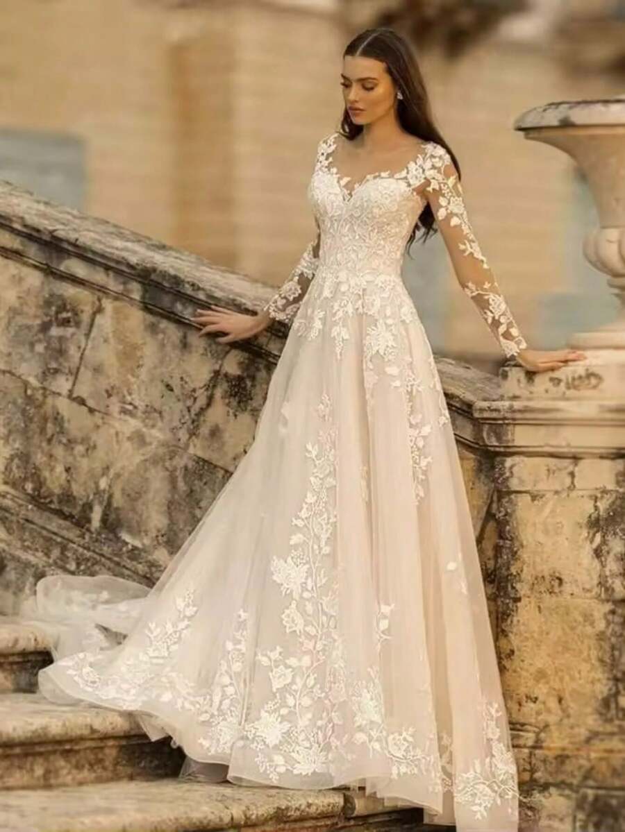 High Waist A-Line Wedding Dress For Women With Deep V Sweetheart Neck And Sheer Mesh Shoulder Detail, Long Sheer Lace Sleeves With Vine Inspired Floral Embroidery, Elegant Bridal Gown Featuring Lace Bodice And Soft Tulle Skirt In Light Champagne Tone, Embroidery Extending From Waist To Hem Creating Elongated Silhouette, Lace Trimmed Train Adding Delicate Detail, Lightweight And Airy Construction For Comfortable Wear, Perfect For Wedding Ceremony, Outdoor Wedding, Garden Party, Christmas Celebration, Holiday Event, Prom Night, Evening Party, Birthday Celebration, Engagement Photoshoot, Soft Feminine Bridal Style - trắng - Xem 1