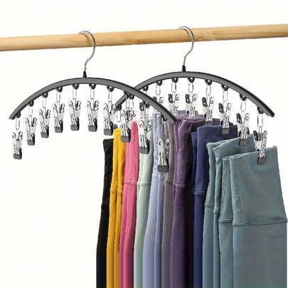 A Metal Hanger With A Polished Surface, A Space-Saving Wardrobe Organizer Featuring 10 Clips - A Versatile Curved Hanger Suitable For Pants, Socks, And Leggings - Durable For Home And Retail Clothing