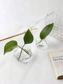 猫形玻璃花瓶，适用于水培和鲜切花——这款装饰性的猫形花盆非常适合水培，是独具特色的家居和办公装饰品。它可以作为餐桌摆饰、卧室花瓶，也是送给爱猫人士和植物爱好者的贴心礼物。非常适合种植绿萝、富贵竹、香草和小花束。 - 無色 - 查看 5