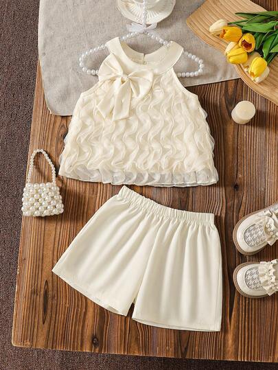 Bộ đồ thời trang thường ngày dễ thương cho bé gái, áo gile lưới xếp ly thắt nơ + quần short trơn cùng màu.