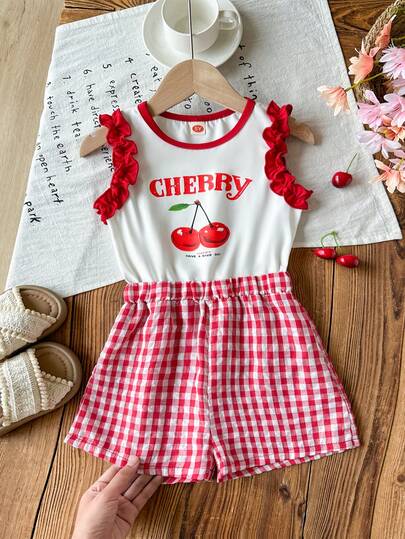 Bộ jumpsuit thời trang nữ trẻ trung, dễ thương, tay bồng, in hình quả anh đào và kẻ caro.