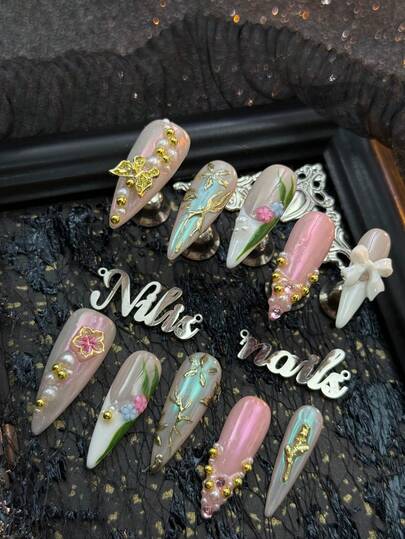 10pcs Stiletto Acrylic Nail Kit, Apricot Colored Nails, White French Nails, Using Gold For Hand Drawn Geometric Patterns, Hand Drawn Green Leaf Patterns, 3D White Bow&Gold Butterfly&Gold Small Round Bead&Pink Blue Five Petal Flower&White Pearl Nail Accessories