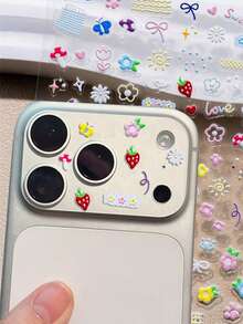 Bộ sticker DIY nơ dâu tây hoạt hình dễ thương phong cách Y2K mùa hè + 2 miếng dán cường lực trong suốt bảo vệ ống kính, tương thích với iPhone 17 Pro Max 17 Pro 17 16 Pro Max 16 Pro 16 15 Pro Max 15 Pro 14 Pro Max 14 Pro 13 12 Pro Max 11 16 15 14 Plus. Phụ kiện dán bảo vệ ống kính chống trầy xước, trong suốt, thích hợp làm quà tặng Ngày của Mẹ, Sinh nhật. - Trong sáng - Xem 5