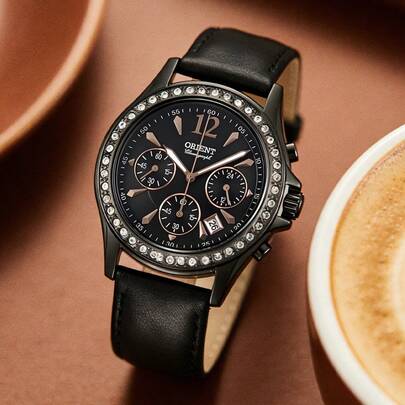 Orient Women's Watch, With A Dark Black Case And Diamond-Studded Bezel, A Three-Hand Chronograph Dial Design That Combines Appearance And Functionality. The Leather Strap Showcases A Unique And Style. This Multi-Functional Women's Wristwatch Is Equipped With An Accurate Quartz Movement, Ensuring Stable Timekeeping.