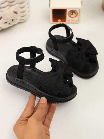 1 Paar schwarze Schleifen-Sandalen für Kleinkind Mädchen, einfarbig, rutschfest, strapazierfähige Gummisohle, modisches weiches PU-Leder, runde Zehenform, geeignet für Mädchen von 3-15 Jahren, für Alltag, Schule, Spazierengehen, Reisen, Outdoor, Zuhause, Partys, Frühling/Sommer 2026 Neuheit